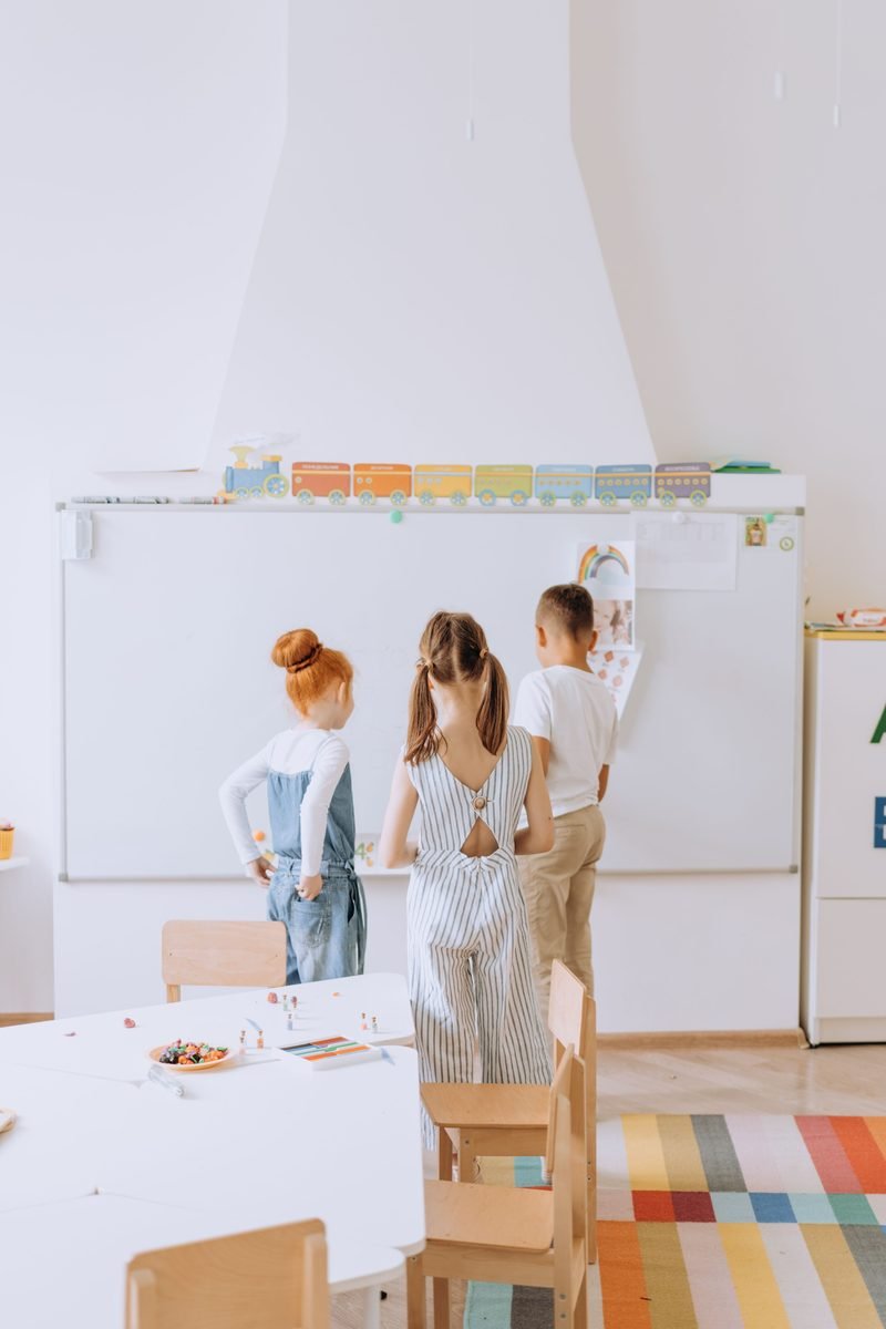 Children working together at a classroom board